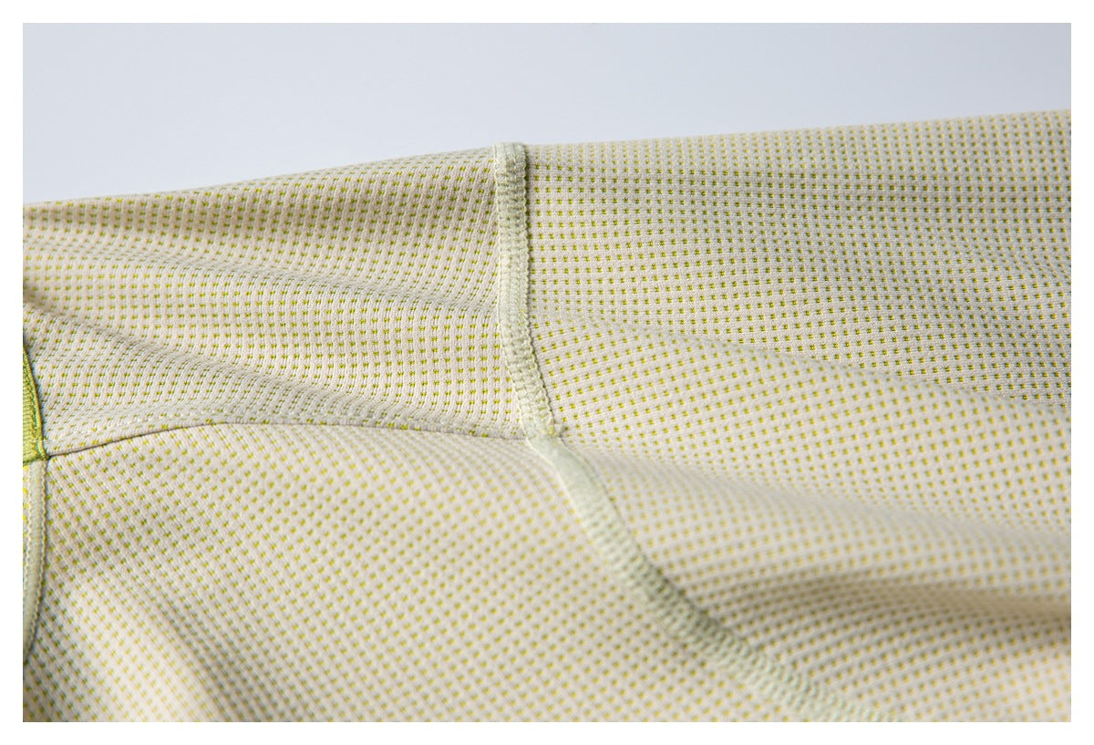 Close-up showing stitched seam construction on cream fabric with a tiny yellow dot pattern.