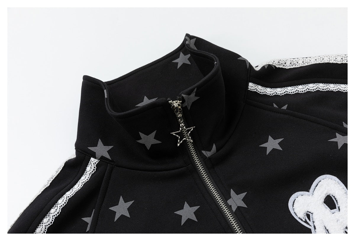Close-up of the black star-print jacket's raised collar, star-shaped zipper pull, white lace sleeve trim and chest patch.