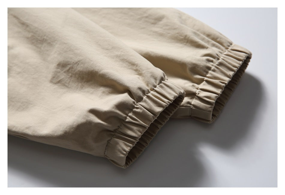 Close-up of the beige jacket's gathered elastic cuffs.