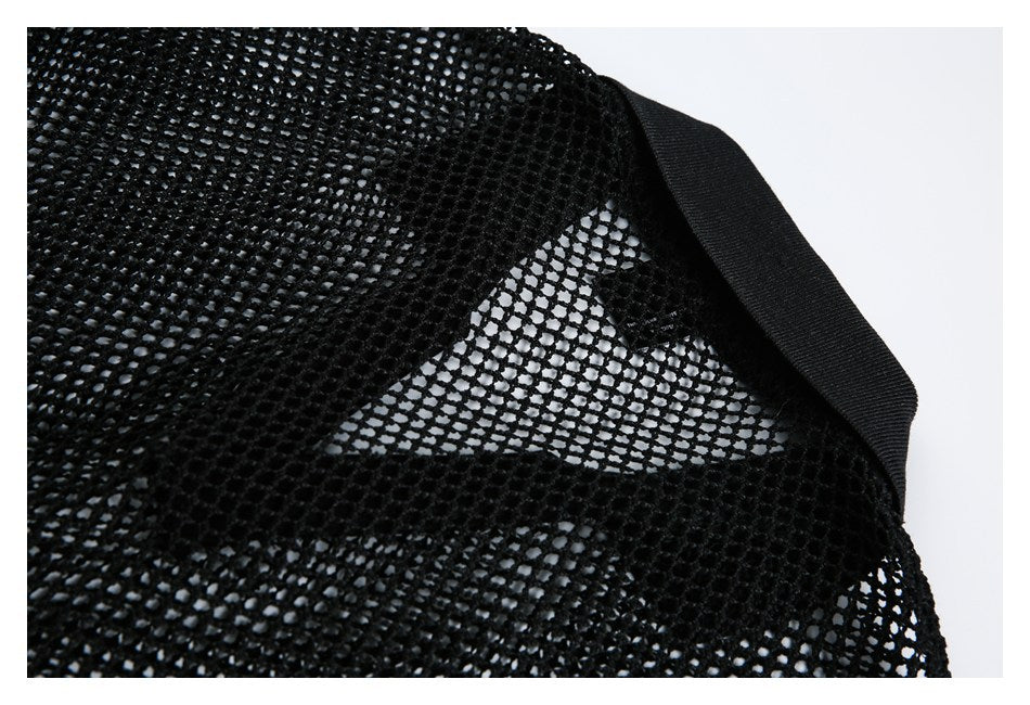Close-up of black mesh construction beside a solid black elastic band.