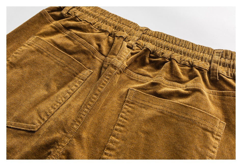 Close-up of the mustard-brown pants’ elastic back waistband and two rear patch pockets.