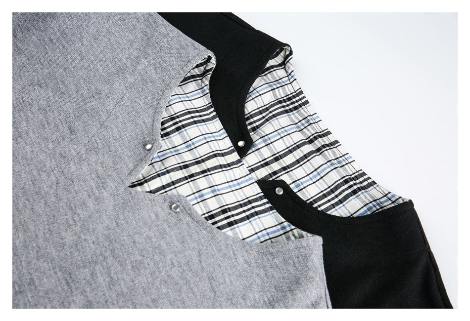 Close-up of gray and black sweatshirt necklines with plaid lining and small metal snaps.