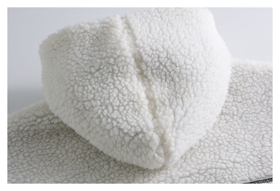 Close-up of plush white sherpa fabric folded over itself on a garment.