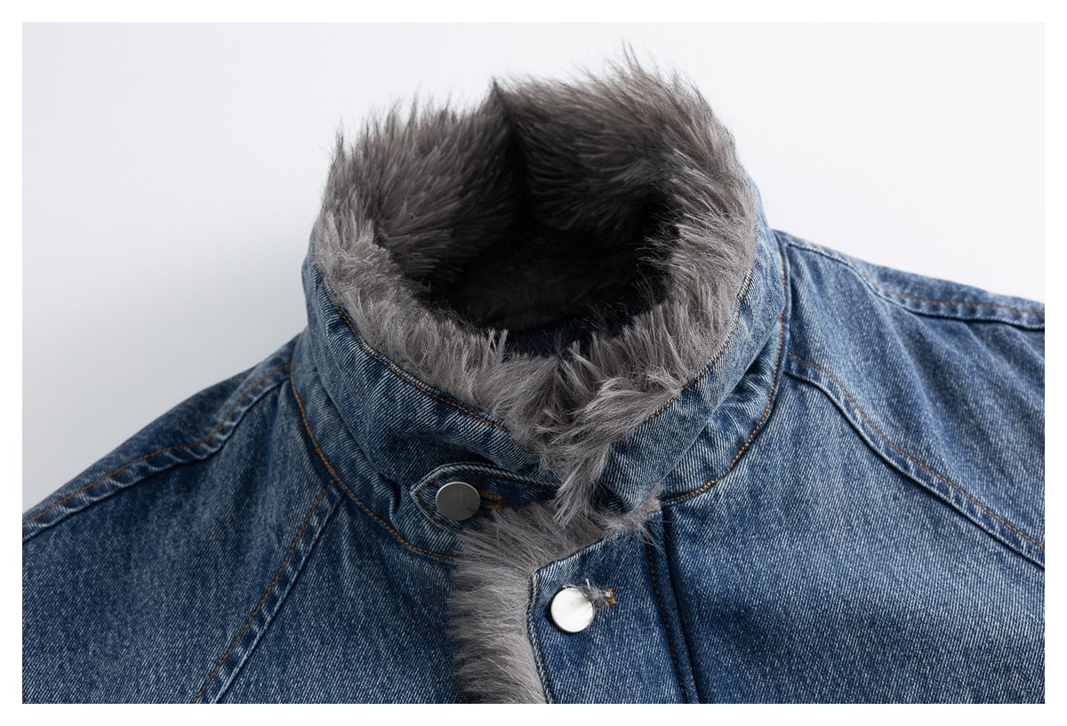 Close-up of a blue denim jacket's high collar and front placket with shaggy gray trim and metal snaps.