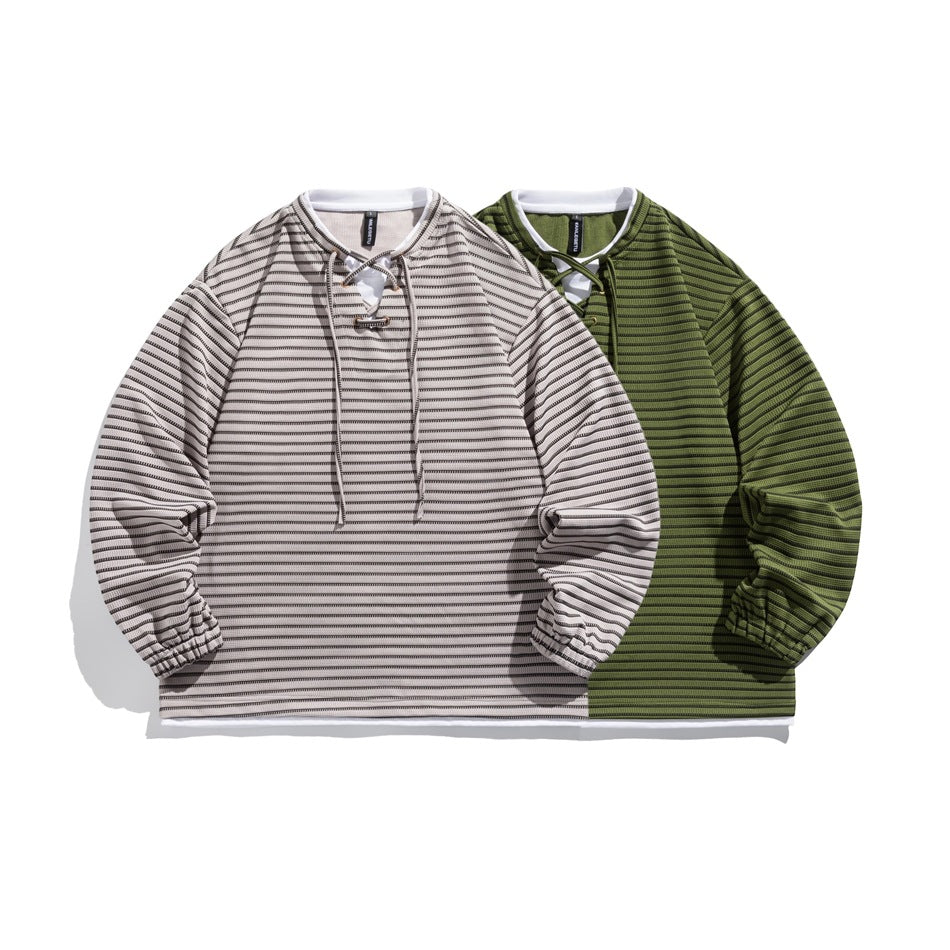 Two long-sleeve lace-up tops shown from the front: one light gray with dark stripes and one olive green with dark stripes.