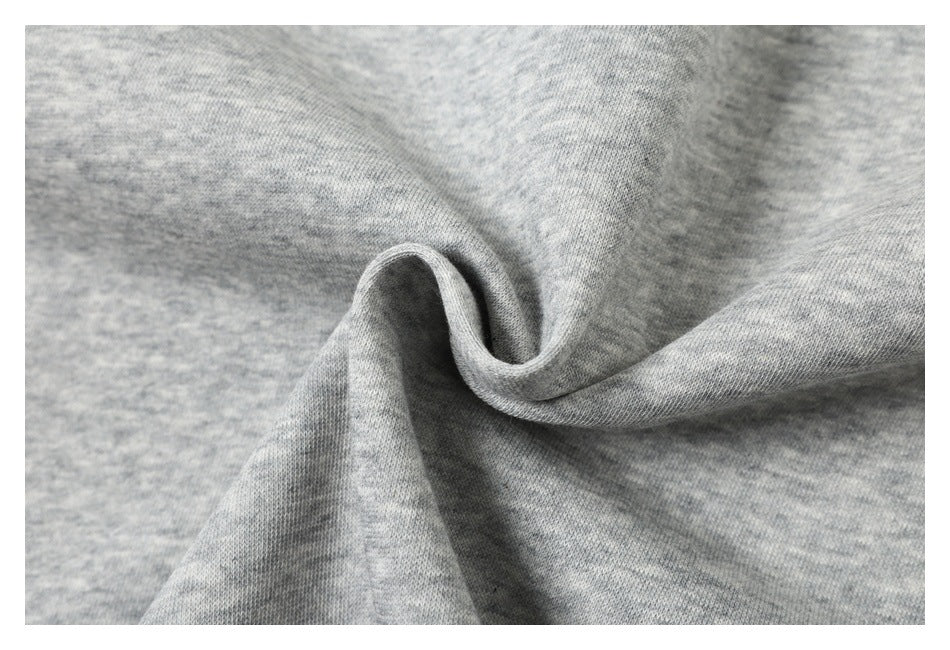 Close-up of heather gray knit fabric gathered into soft folds.