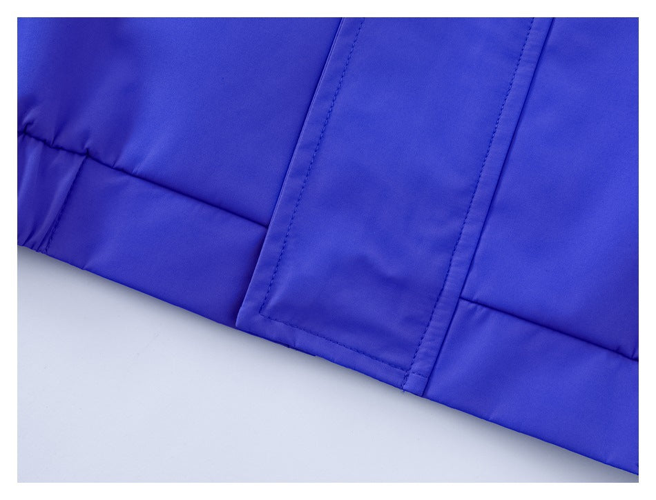 Close-up of a vivid blue garment hem and stitched rectangular flap.