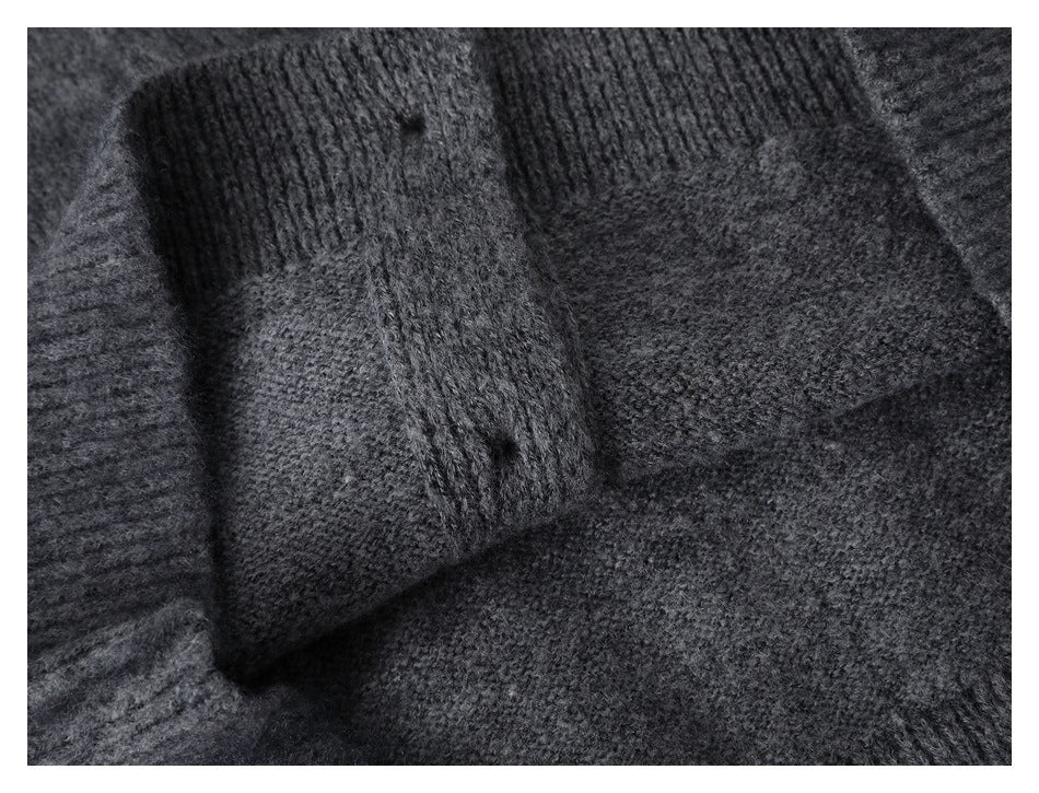 Close-up of the charcoal gray cardigan's ribbed cuff and knit sleeve.