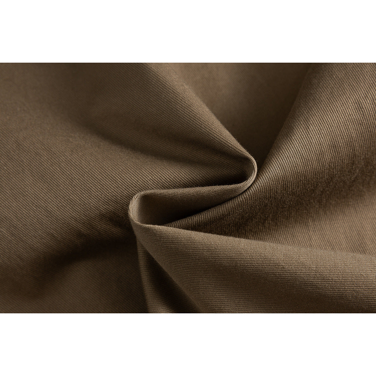 Extreme close-up of brown fabric folded to show its fine ribbed texture.