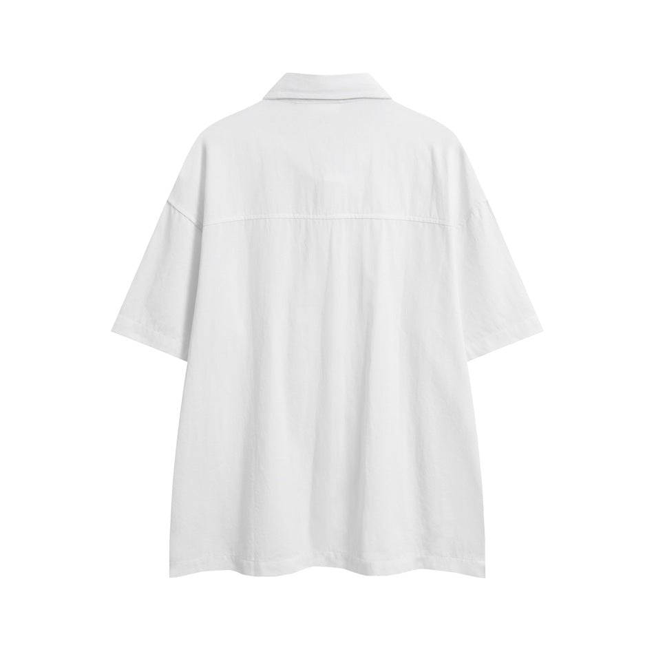 Back view of a loose white short-sleeve collared shirt on a white background.