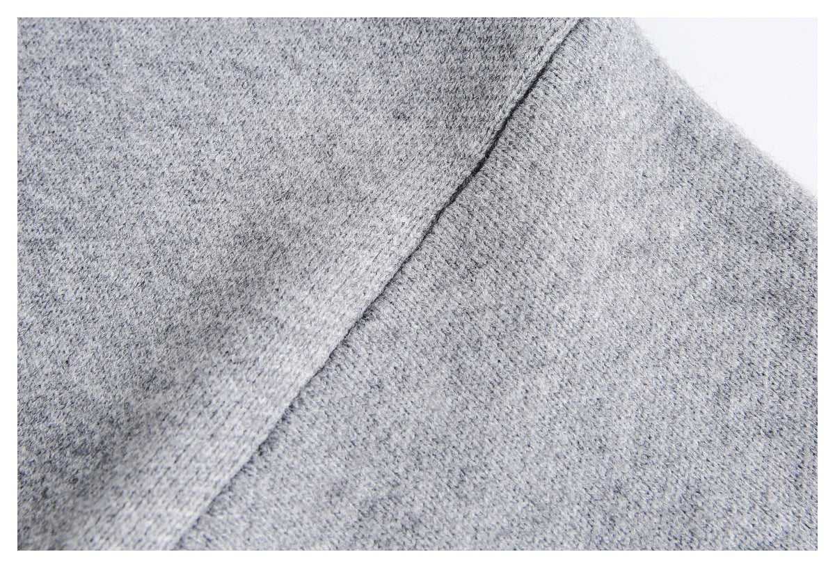 Close-up of gray knit fabric with a diagonal seam joining two panels.
