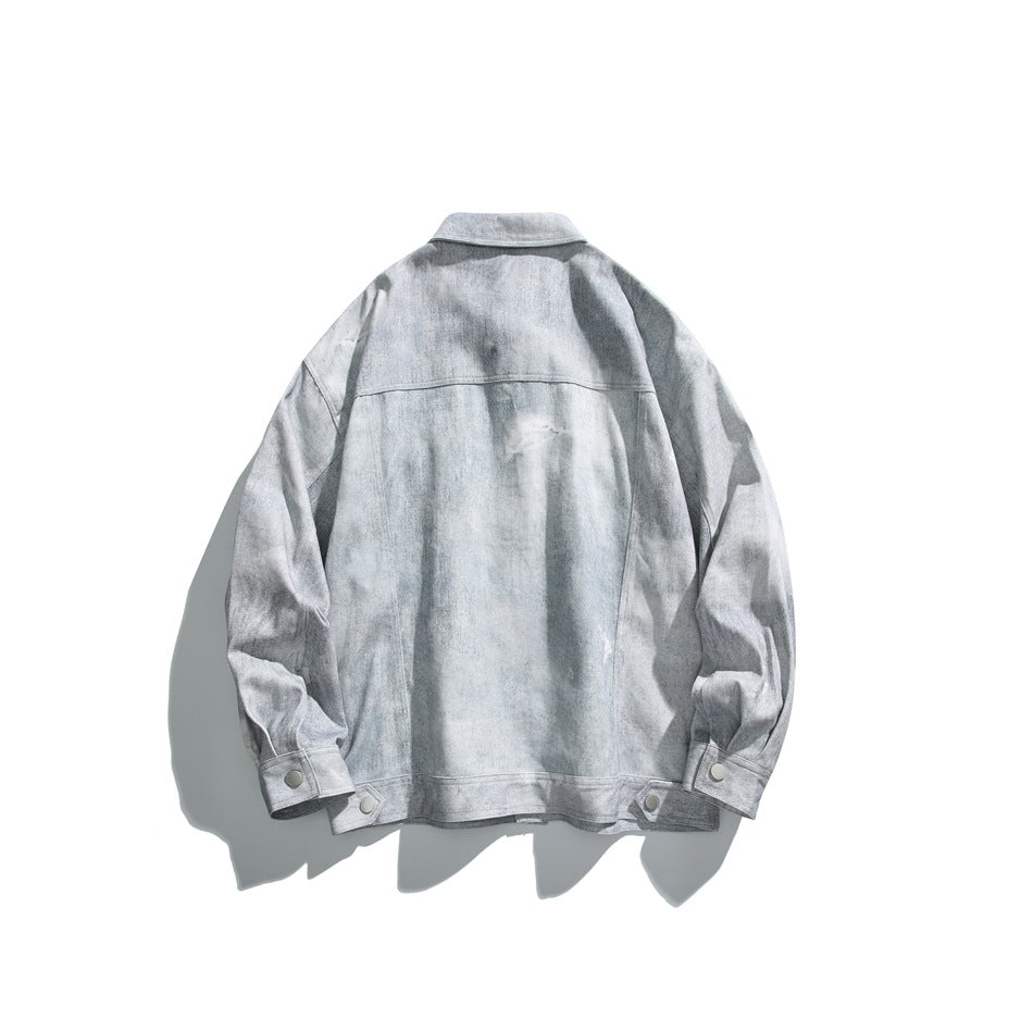 Back view of a light gray washed jacket laid flat, with a pointed collar, long sleeves, and snap cuffs.