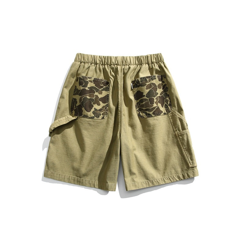 Rear view of olive green shorts with an elastic waistband, camouflage-print patch pockets, and side cargo pockets.