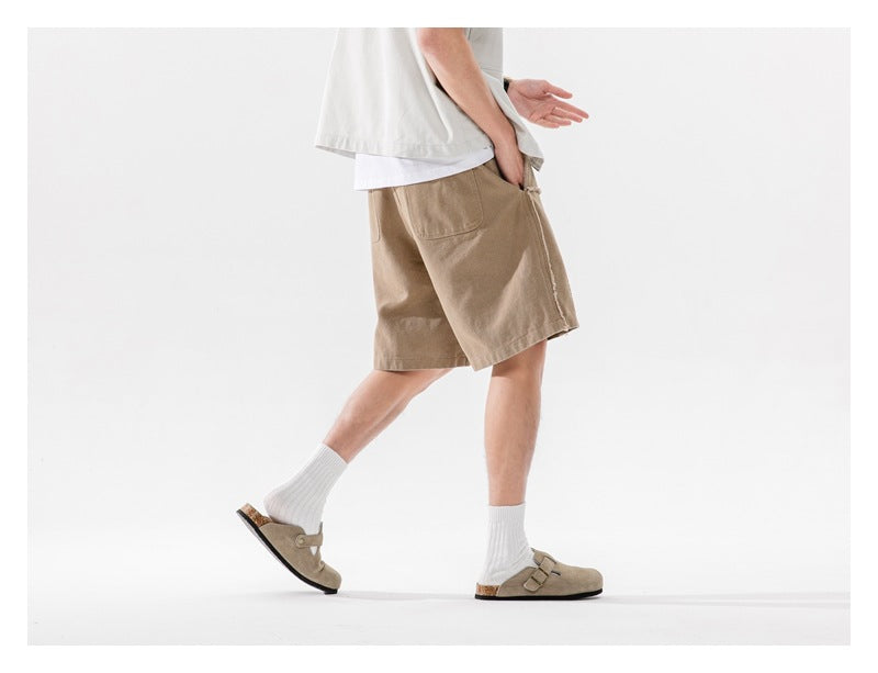Model wearing tan shorts, shown from the side with a rear patch pocket visible.