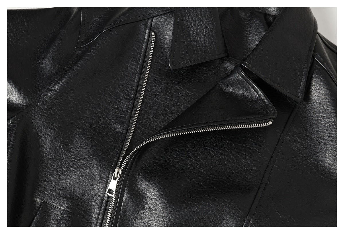 Close-up of a black jacket's notched lapel and diagonal silver front zipper.
