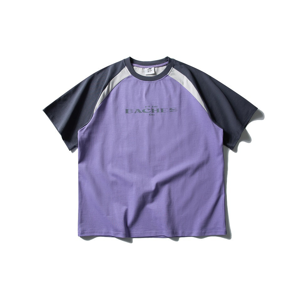 Front view of a purple raglan T-shirt with charcoal sleeves, gray shoulder panels, and small chest lettering.