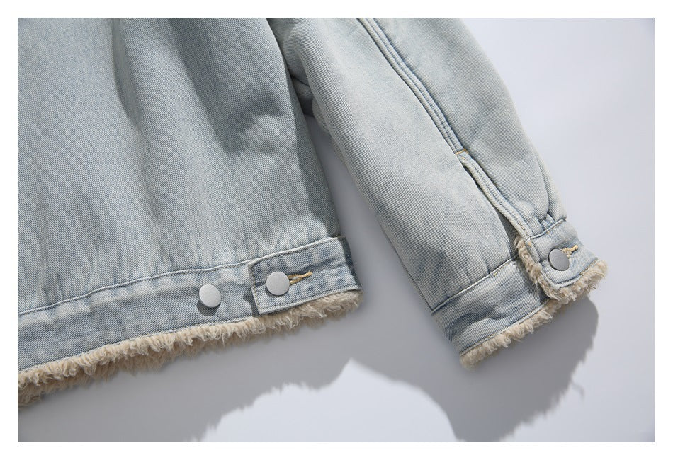 Close-up of the denim jacket's lower back hem and sleeve cuff, both edged with cream fringe and silver snaps.