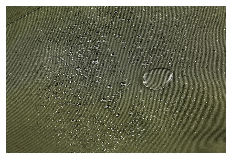 Water droplets bead on olive-green fabric in a close-up view.