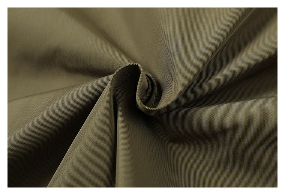 Olive fabric gathered into a twist, showing its texture and drape.
