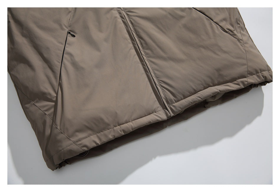 Close-up of the taupe garment's lower front, showing a central zipper, side seam, and hem.