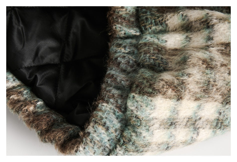 Close-up showing the black lining and fuzzy patterned outer fabric of a coat.