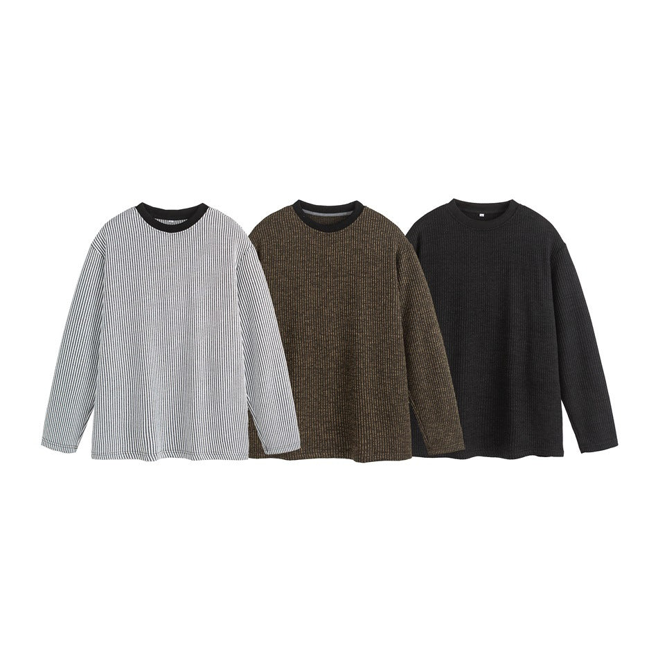 Three long-sleeve crewneck tops shown together: gray-and-white stripes, dark brown texture, and black.