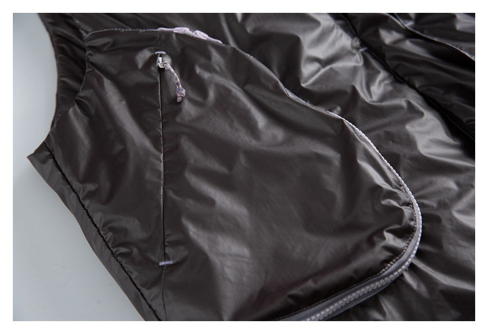 Close-up of a dark vest's curved zip pocket with a corded zipper pull.