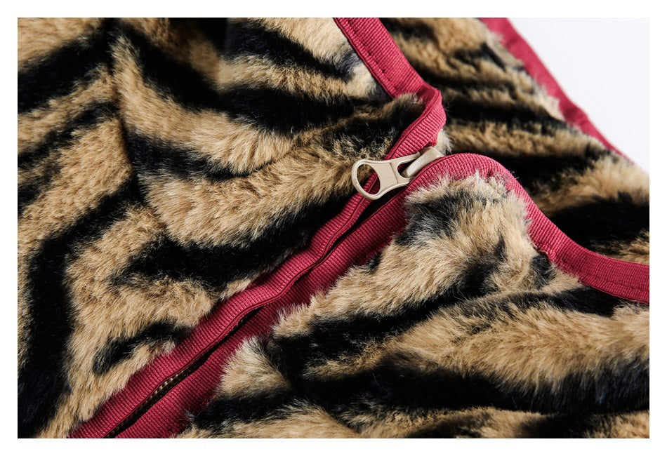 Close-up of the garment's burgundy zipper and trim against tan-and-black tiger-striped plush fabric.
