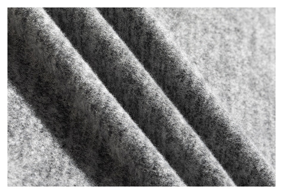 Macro view of the gray marled top's soft-looking, flecked surface and folds.