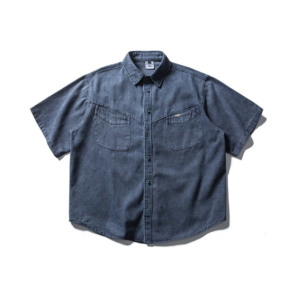 Blue-gray washed short-sleeve button-front shirt with two chest flap pockets, flat lay front view