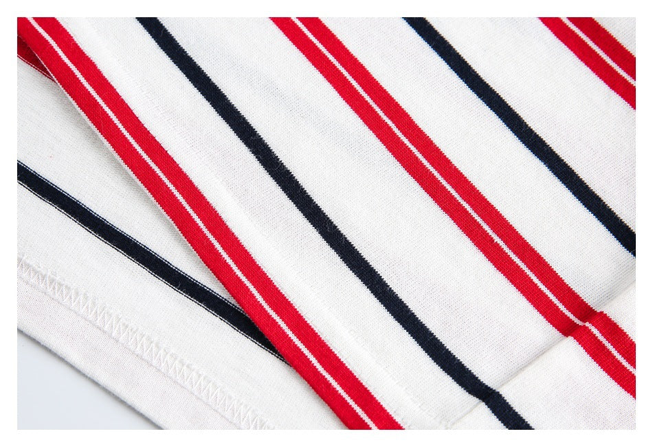 Close-up of the hem and stitching on white fabric with red and navy stripes.