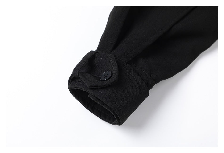 Close-up of a black sleeve cuff with a buttoned tab.