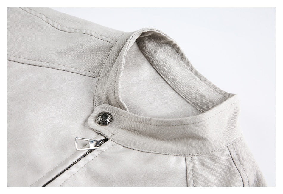 Close-up of the light gray jacket's stand collar, zipper, stitching, and decorative snap.