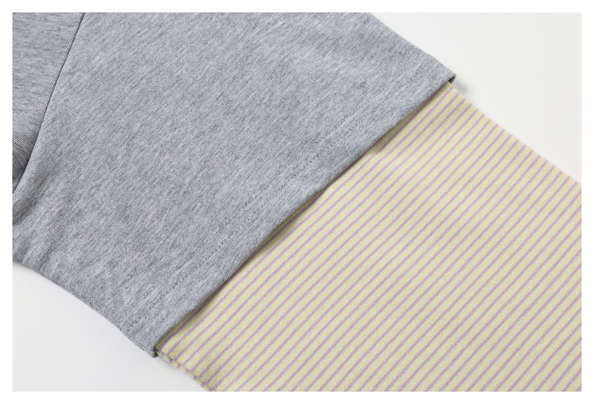 Gray sleeve joined to a pale yellow cuff with narrow purple stripes.