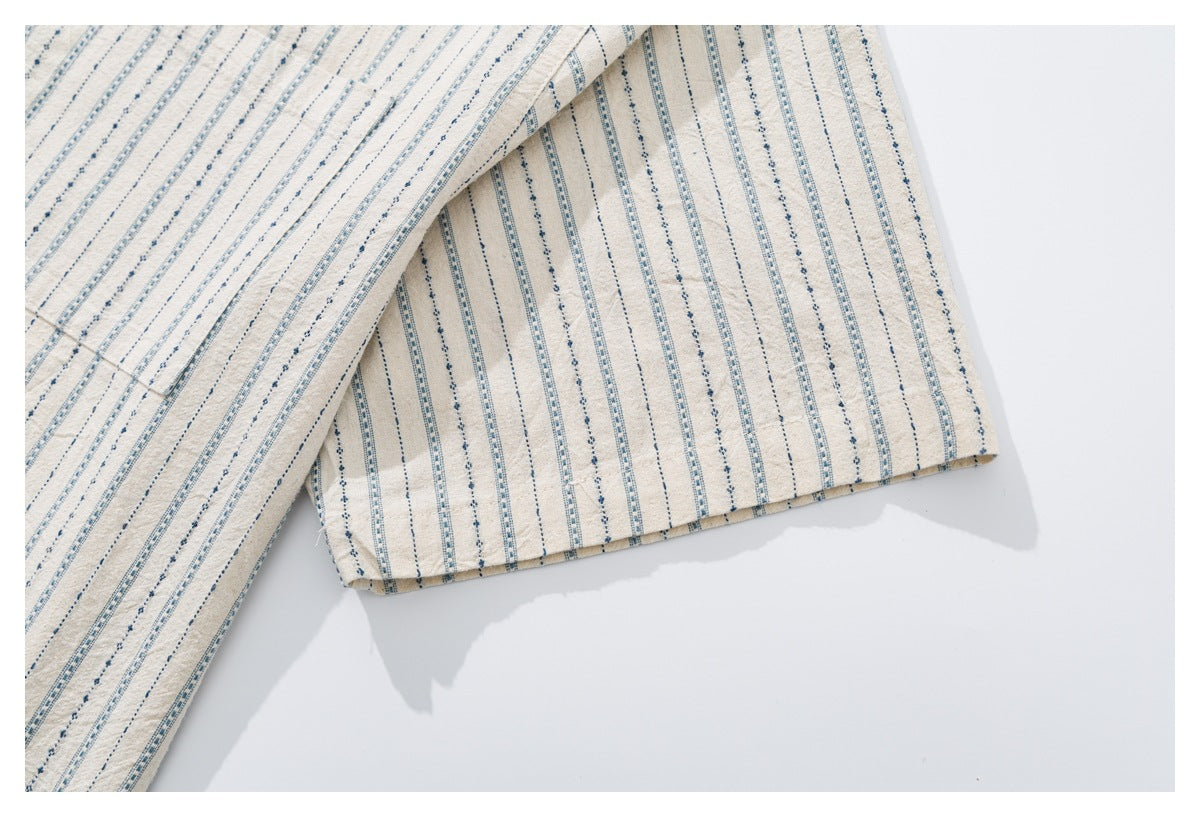 Close-up of the off-white shirt's striped short sleeve and folded cuff.