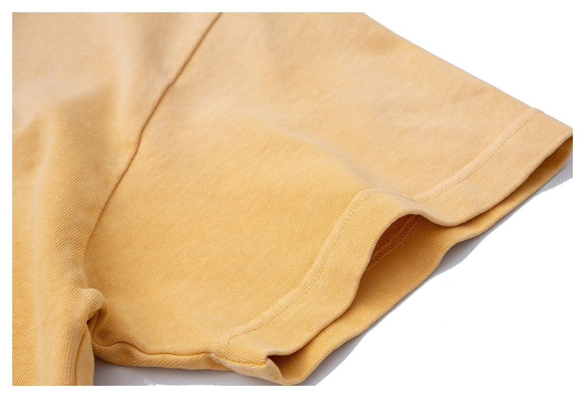 Close-up of the golden-yellow sweatshirt sleeve and stitched cuff.
