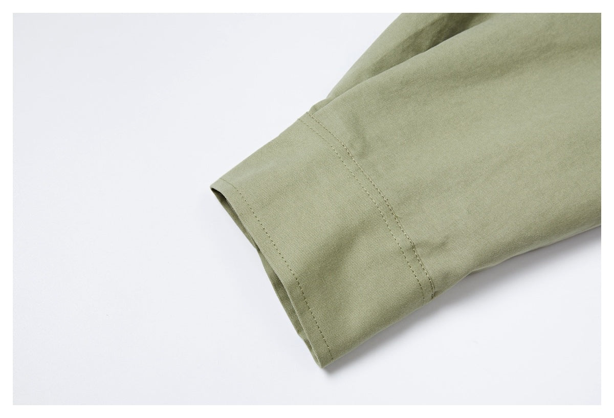 Close-up of an olive garment sleeve cuff with visible stitching and a clean folded edge.