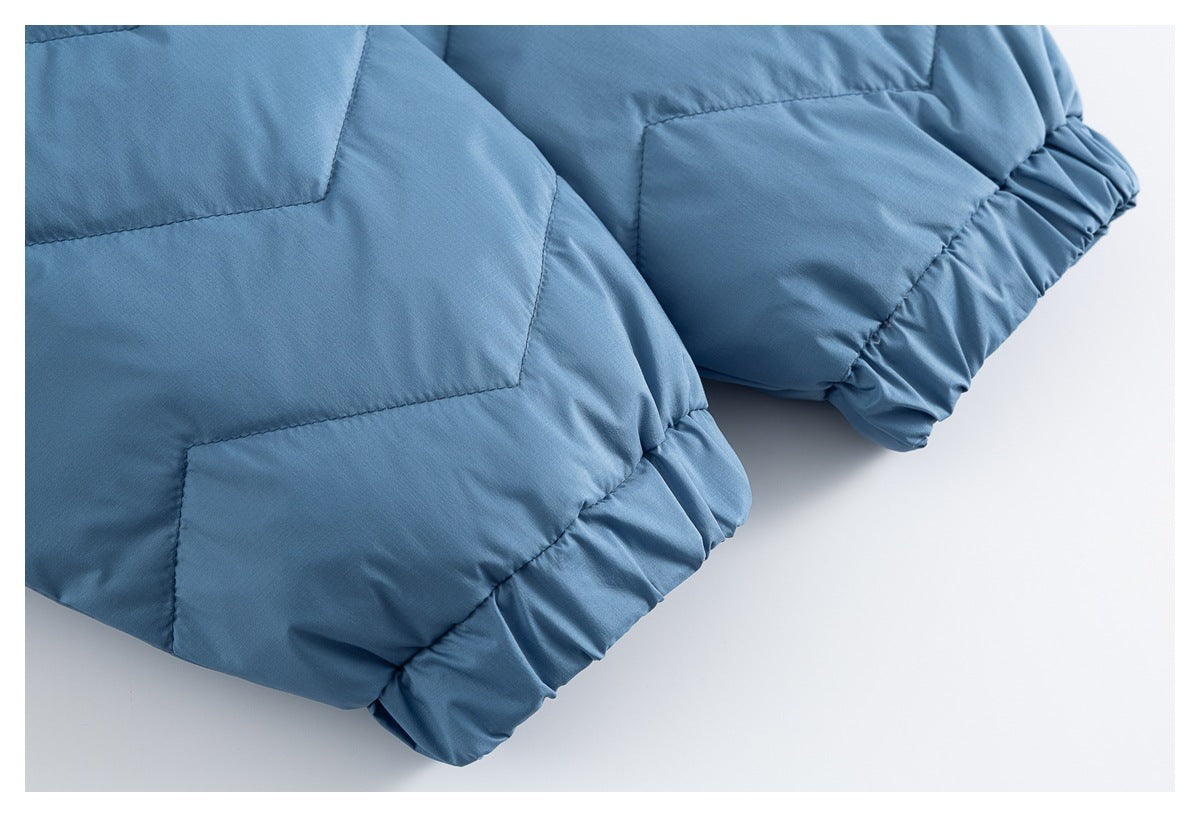 Close-up of a blue quilted jacket sleeve with gathered elastic cuff and stitched panels.