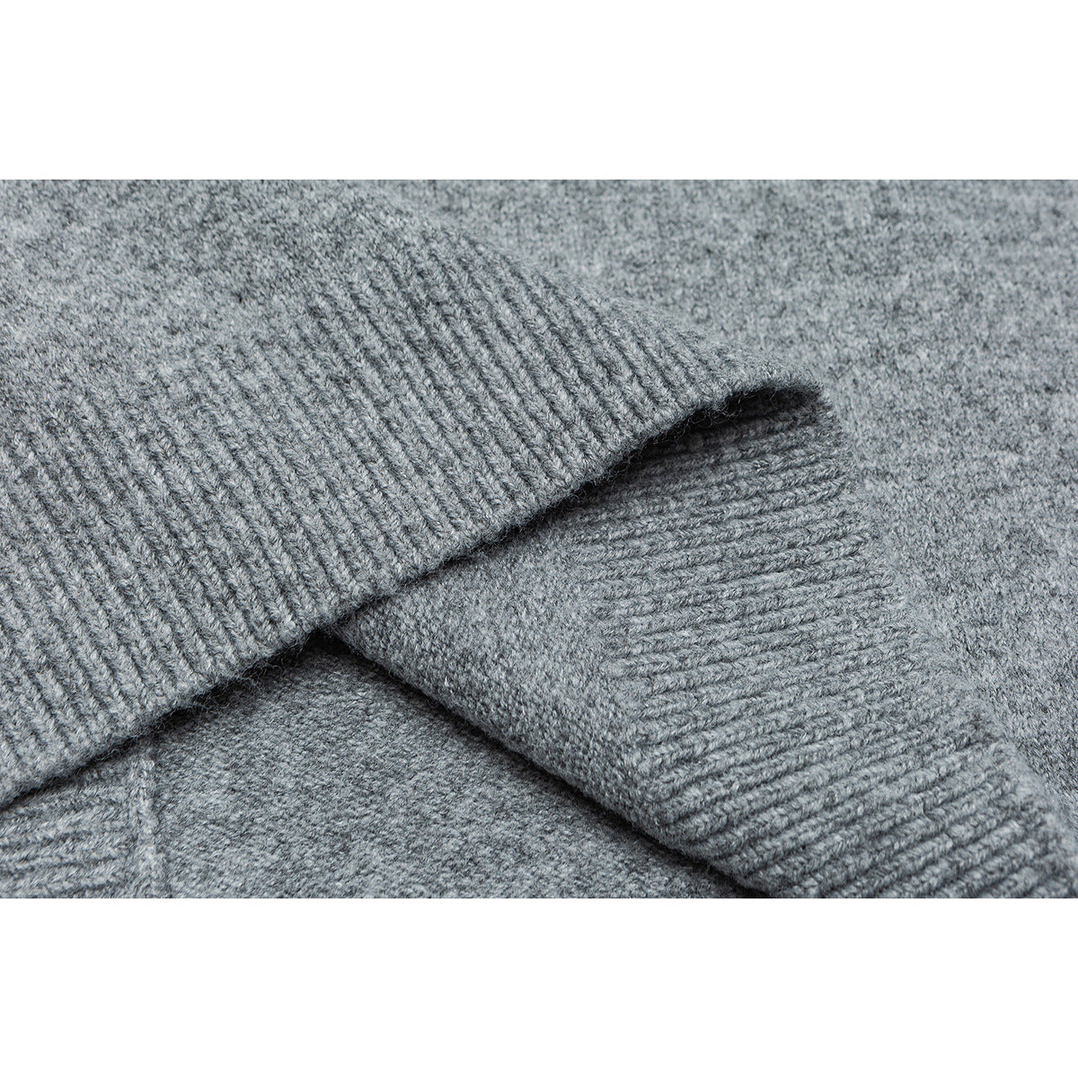 Close-up of overlapping ribbed cuffs and gray knit fabric.
