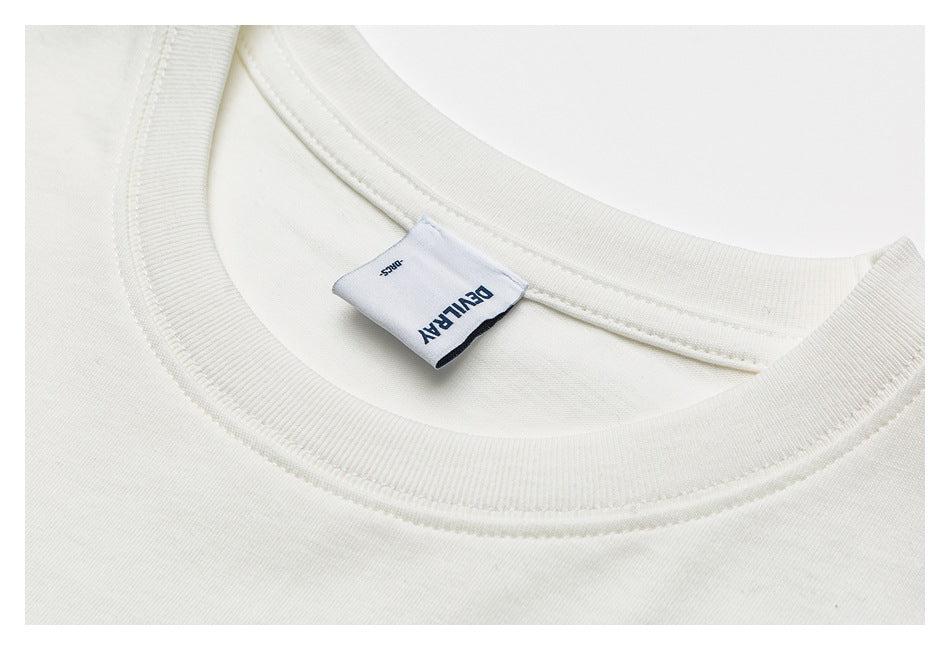 Close-up of an ivory crew-neck shirt collar and sewn-in neck label.