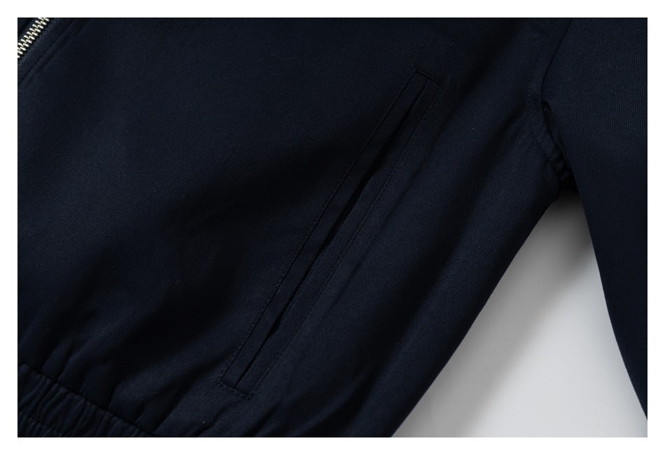 Close-up of a slanted welt pocket on the navy jacket.