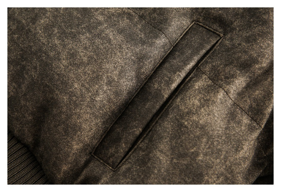 Close-up of a narrow welt pocket on the mottled brown jacket, with ribbed trim visible at the edge.