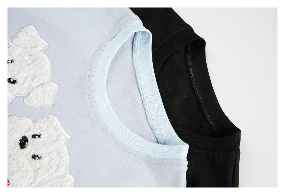 Close-up of pale blue and black tops showing their ribbed crew necklines.