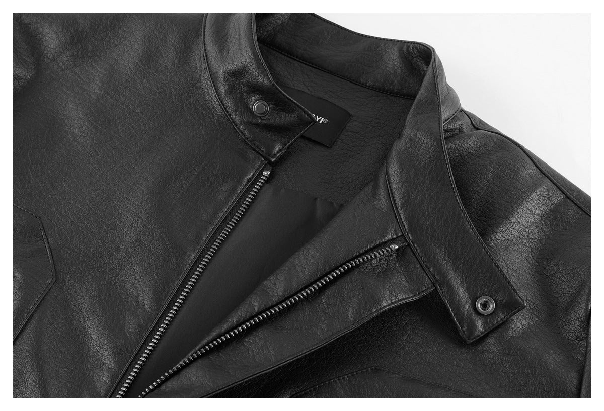 Close-up of a black jacket with an open snap collar, front zipper and diagonal zip pocket.