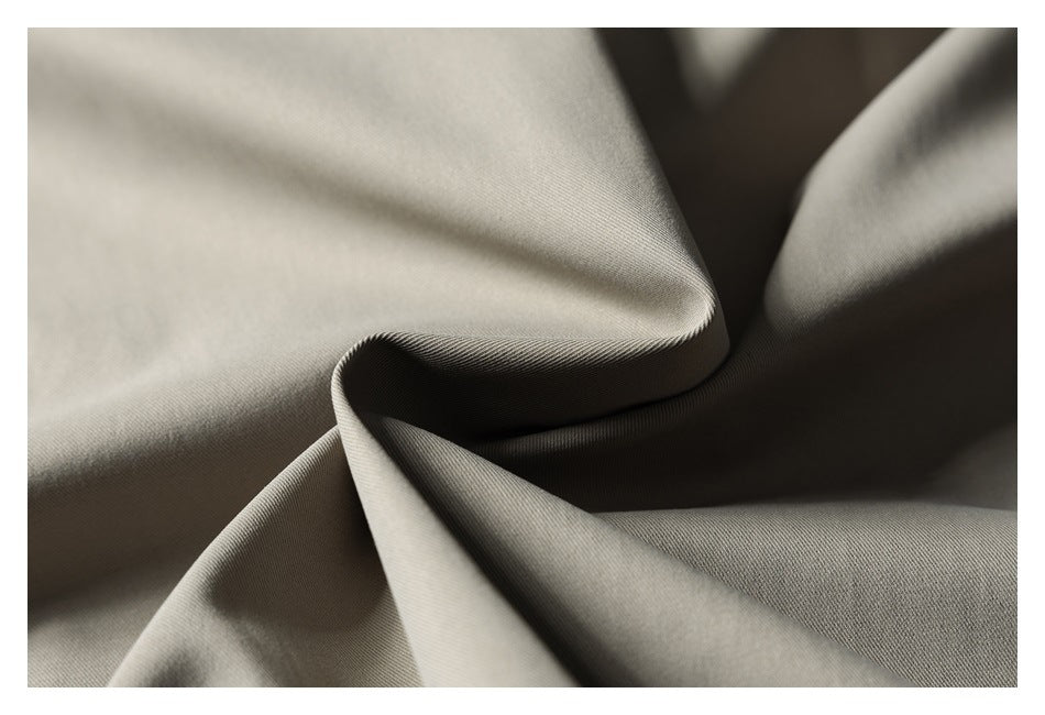 Close-up of taupe-gray fabric folded to show its smooth surface and fine weave.