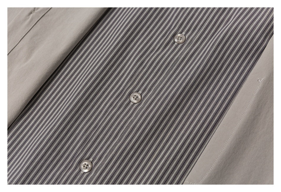 Close-up of a gray striped shirt panel with buttons, framed by taupe fabric.