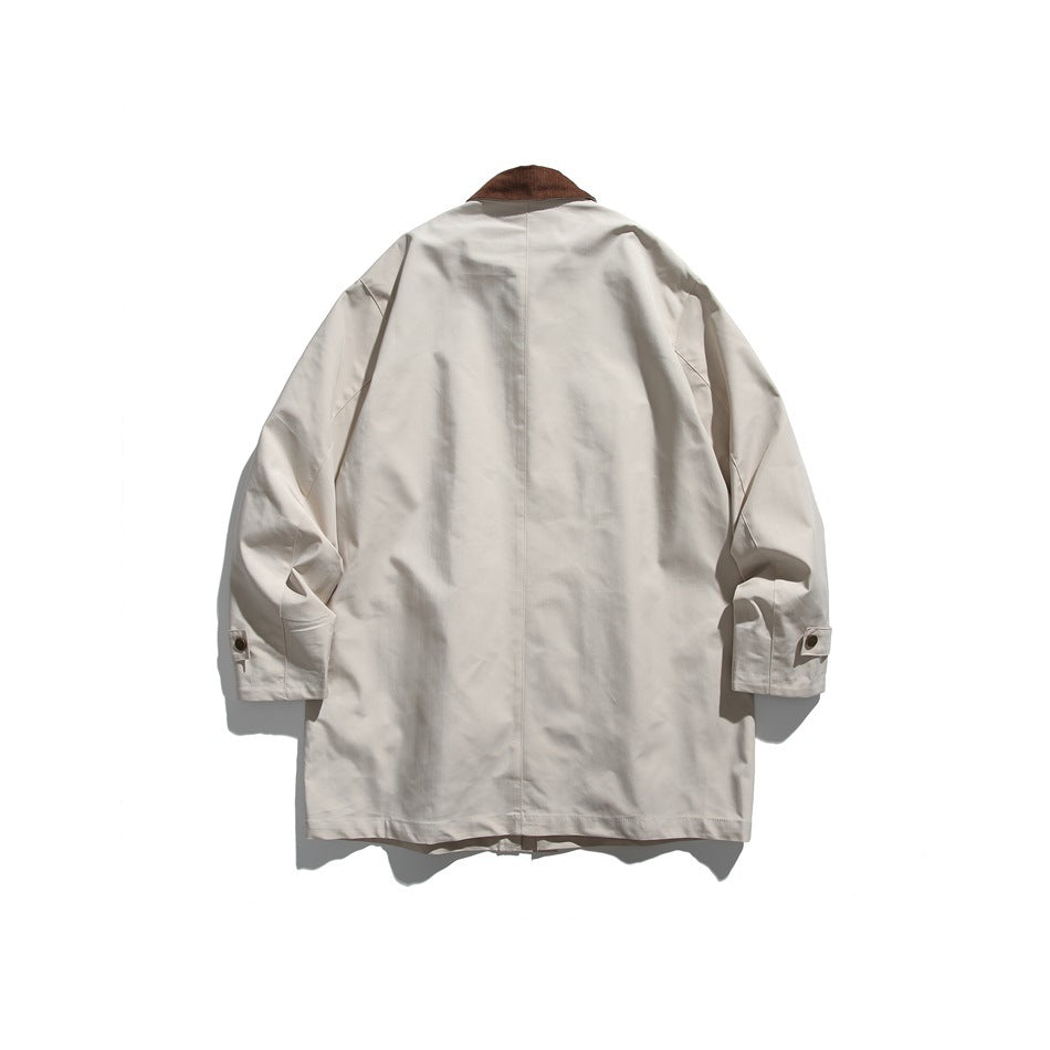 Back view of a light beige jacket with a brown collar, center seam, and snap-tab cuffs.