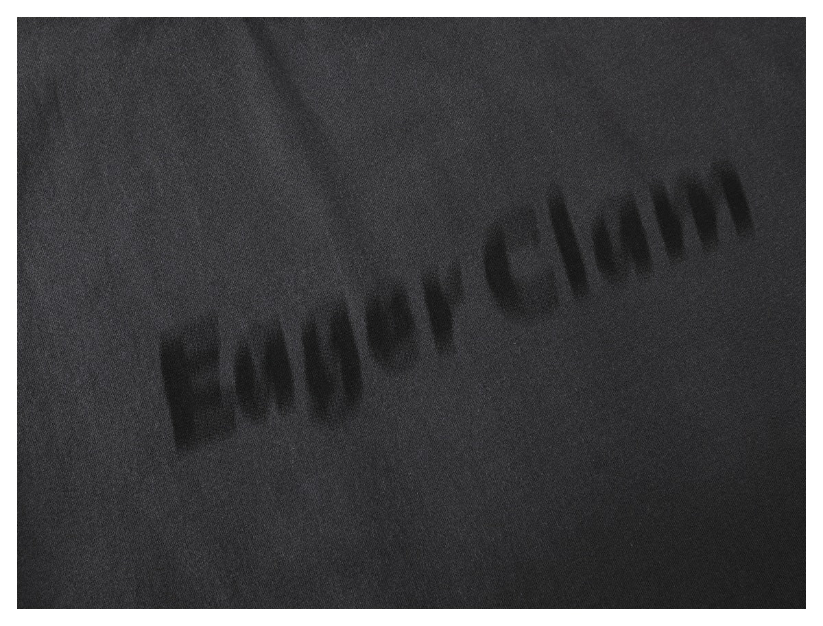 Close-up of dark tonal lettering printed on black fabric.