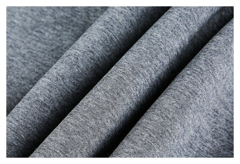 Macro view of gray heathered fabric arranged in folds.