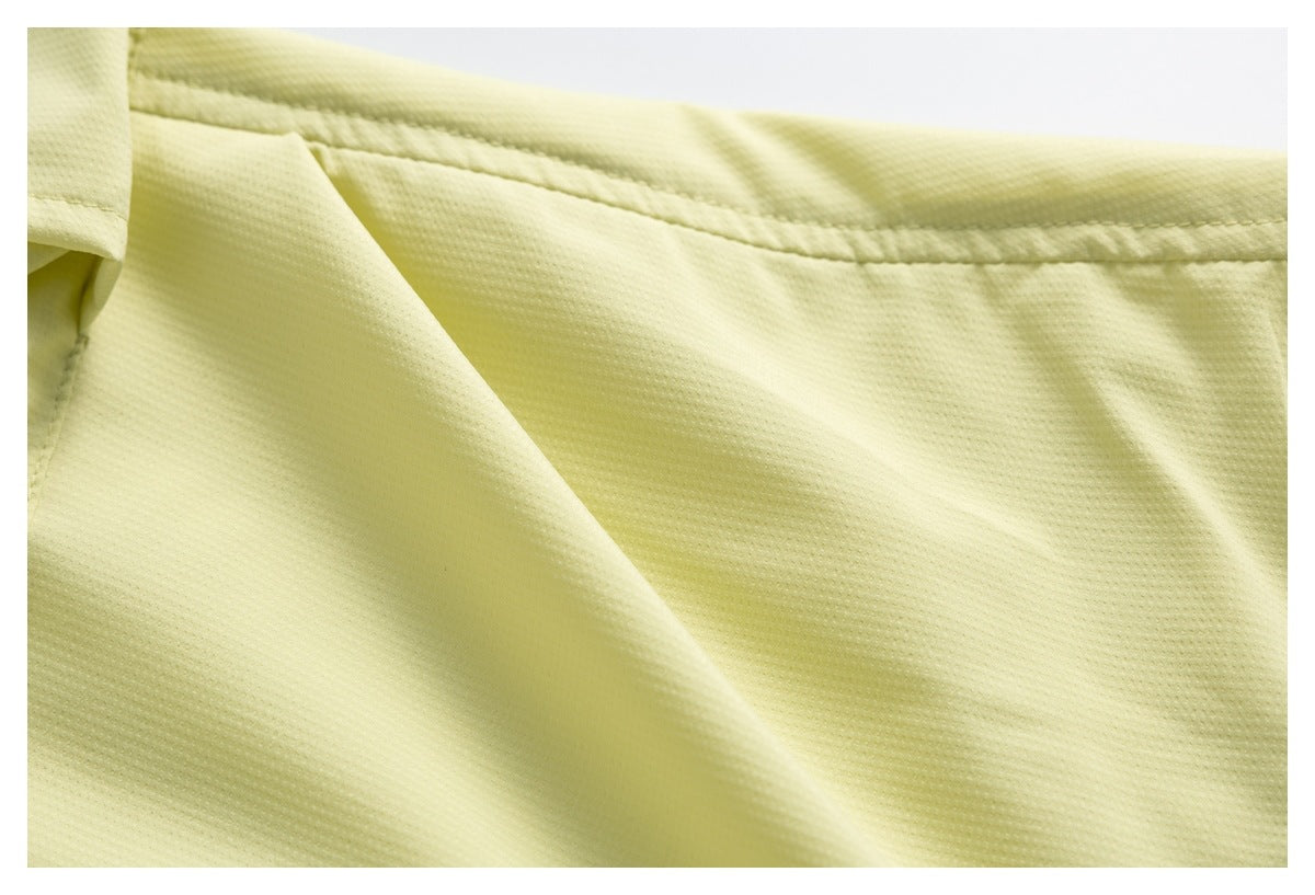 Close-up of pale yellow garment fabric and a horizontal stitched seam near a pocket.